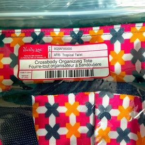 New in package. Thirty One Crossbody Organizing Tote.